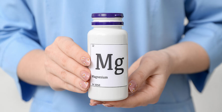 Female Doctor Holding Bottle Magnesium Pills