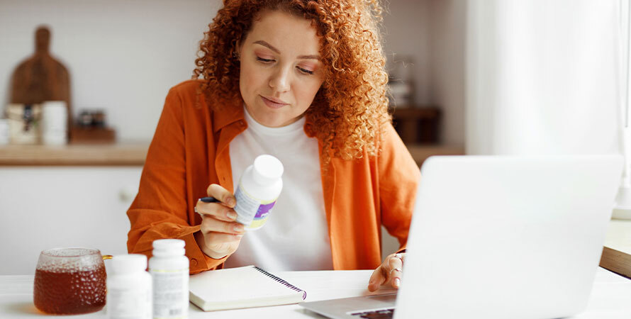Nutritionist analyzing supplements at home.