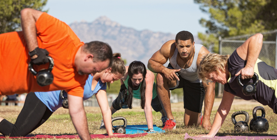 Fitness instructor people exercising outdoor bootcamp
