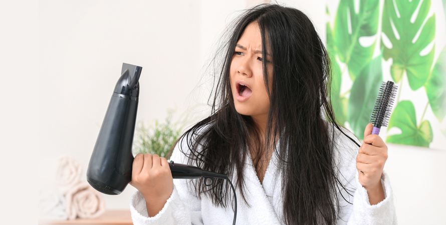 Stressed asian woman hair dryer home